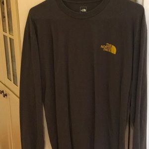 Two men’s long sleeved north face shirts